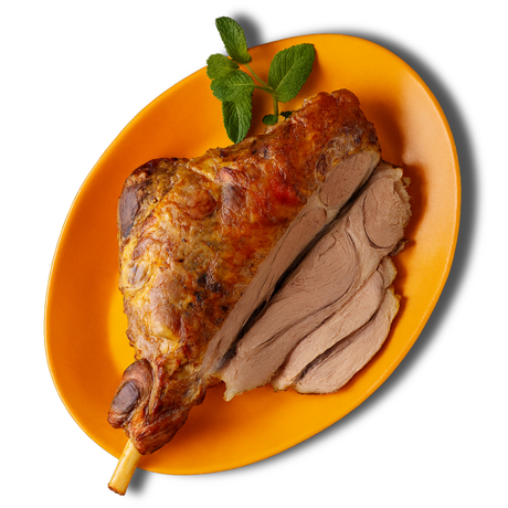 Prime Range Fresh Roast lamb on an orange plate with a sprig of mint