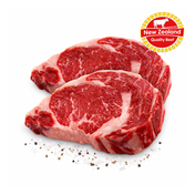Two raw beef steaks with New Zealand Quality Beef logo on a white background